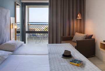 a room with a bed and a chair and a book