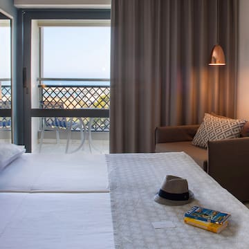 a room with a bed and a chair and a book