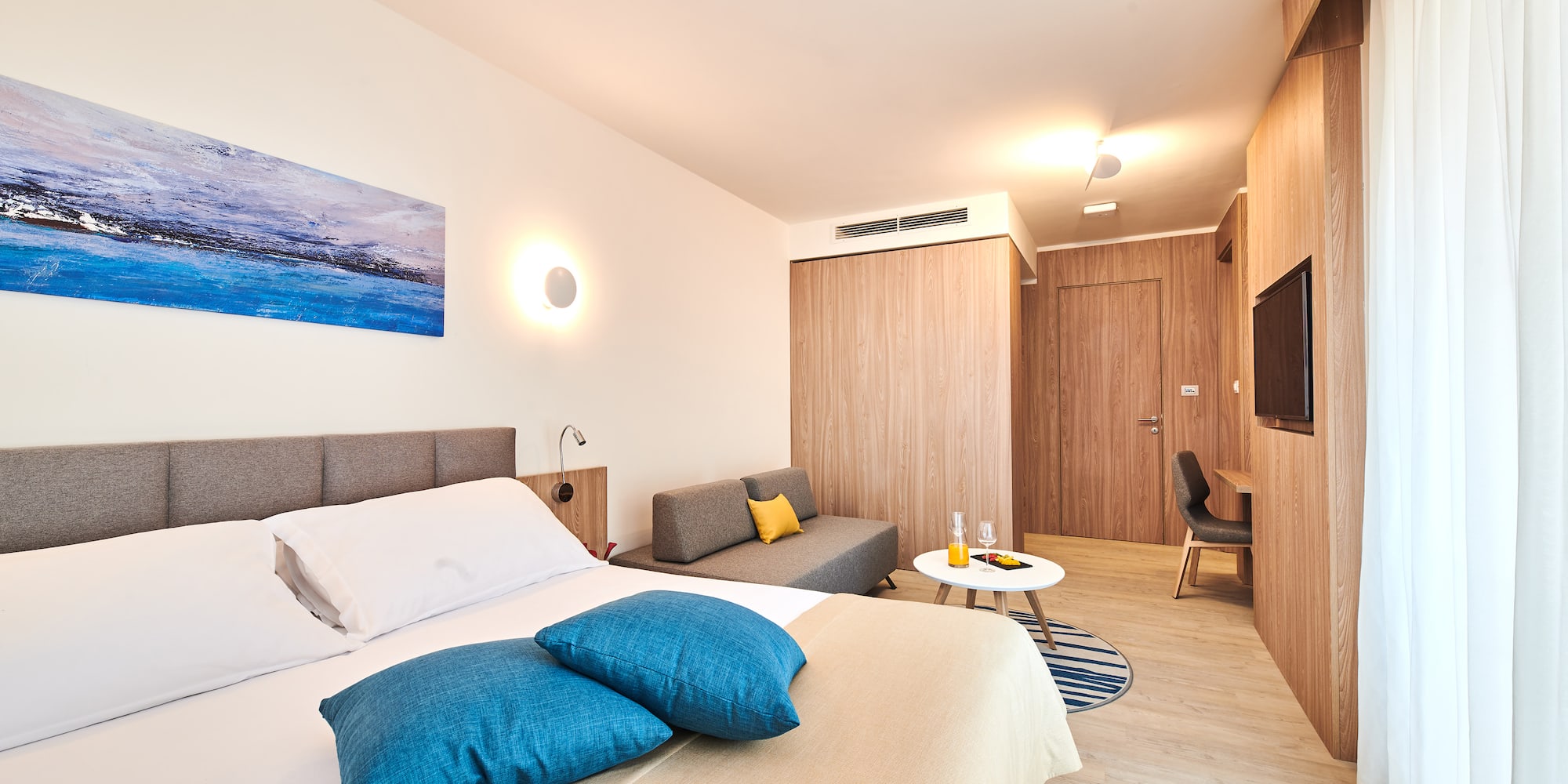 a bedroom with a bed and a television