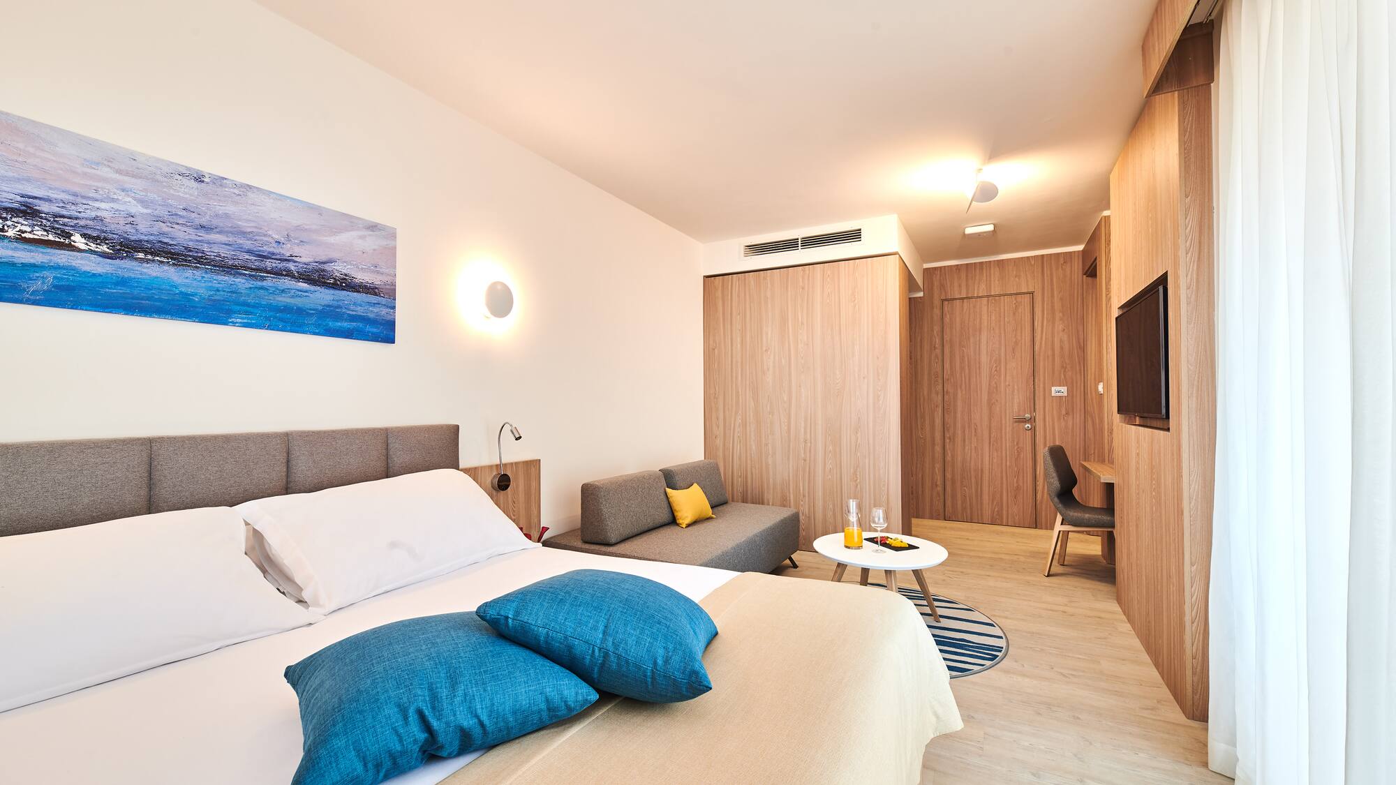 a bedroom with a bed and a television