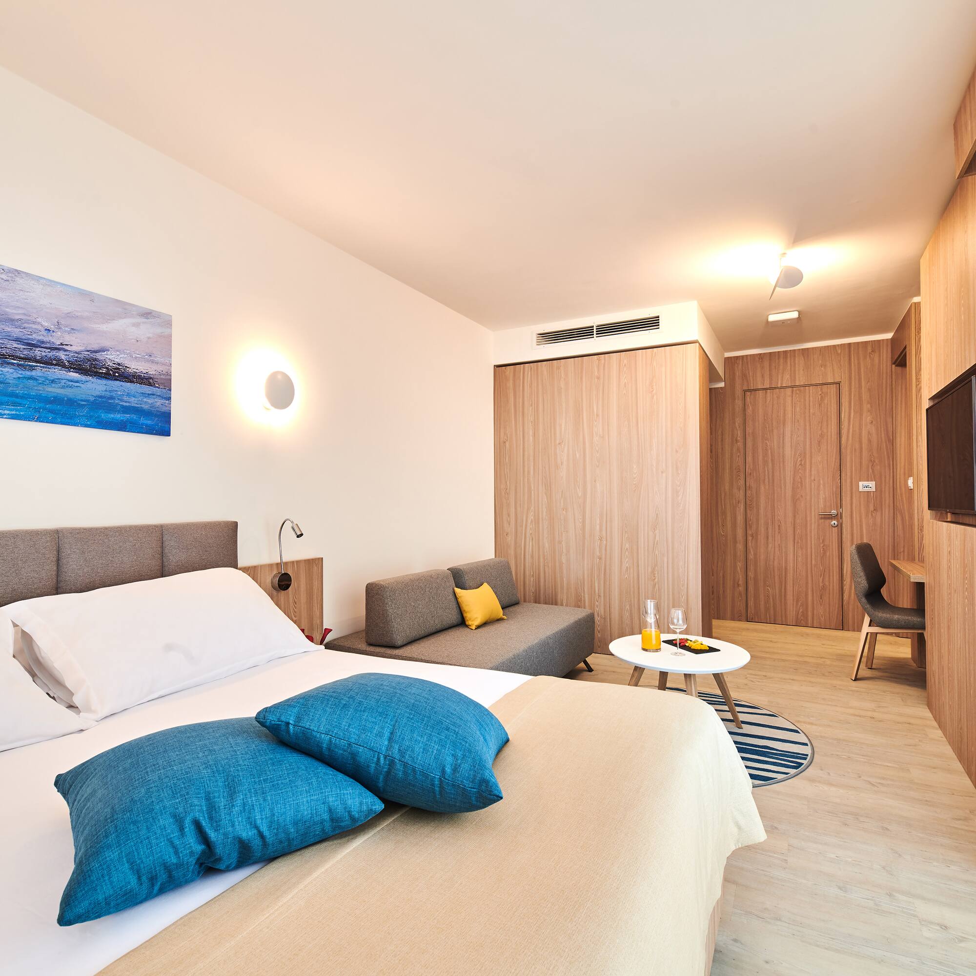 a bedroom with a bed and a television