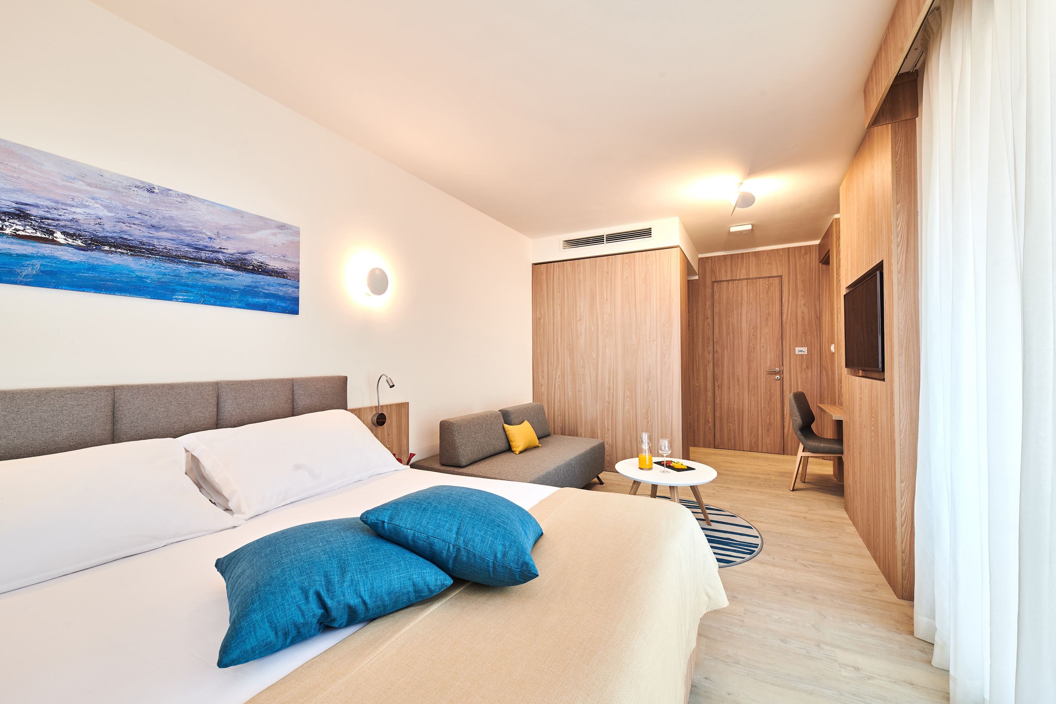 a bedroom with a bed and a television - Family Room - Garden Suites Umag Plava Laguna Affiliated by Meliá, Umag