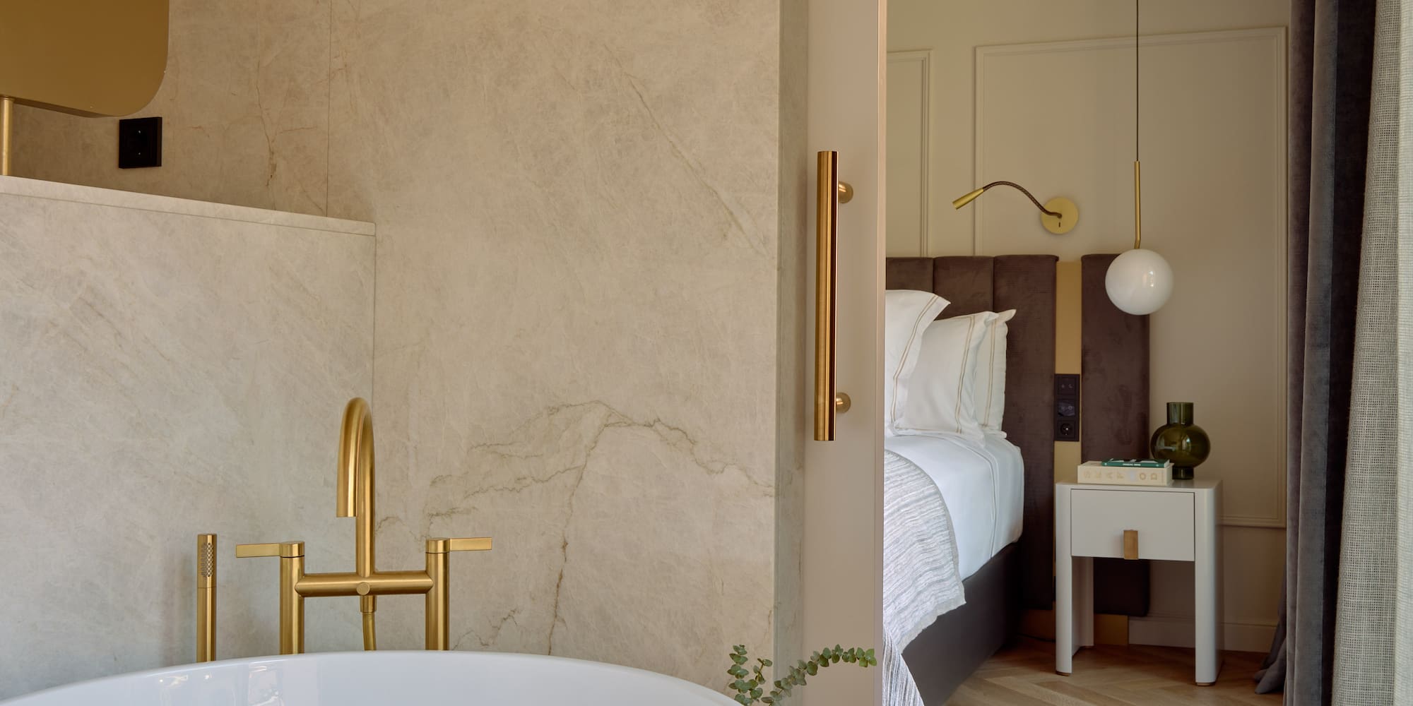 a bathroom with a bathtub and a bed