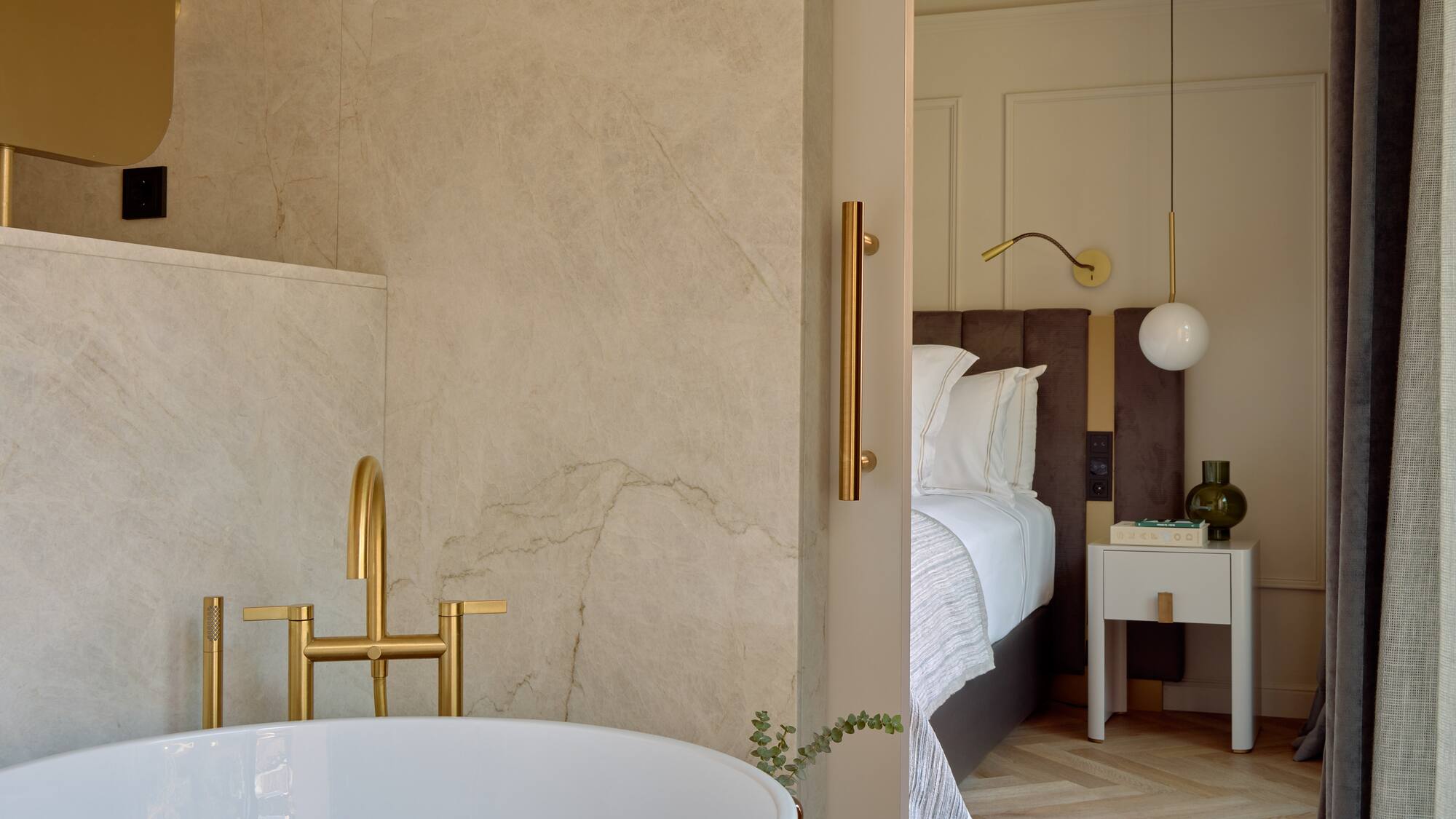 a bathroom with a bathtub and a bed