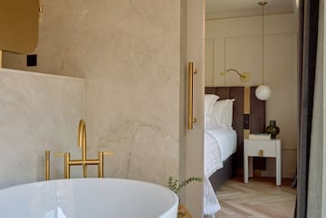 a bathroom with a bathtub and a bed