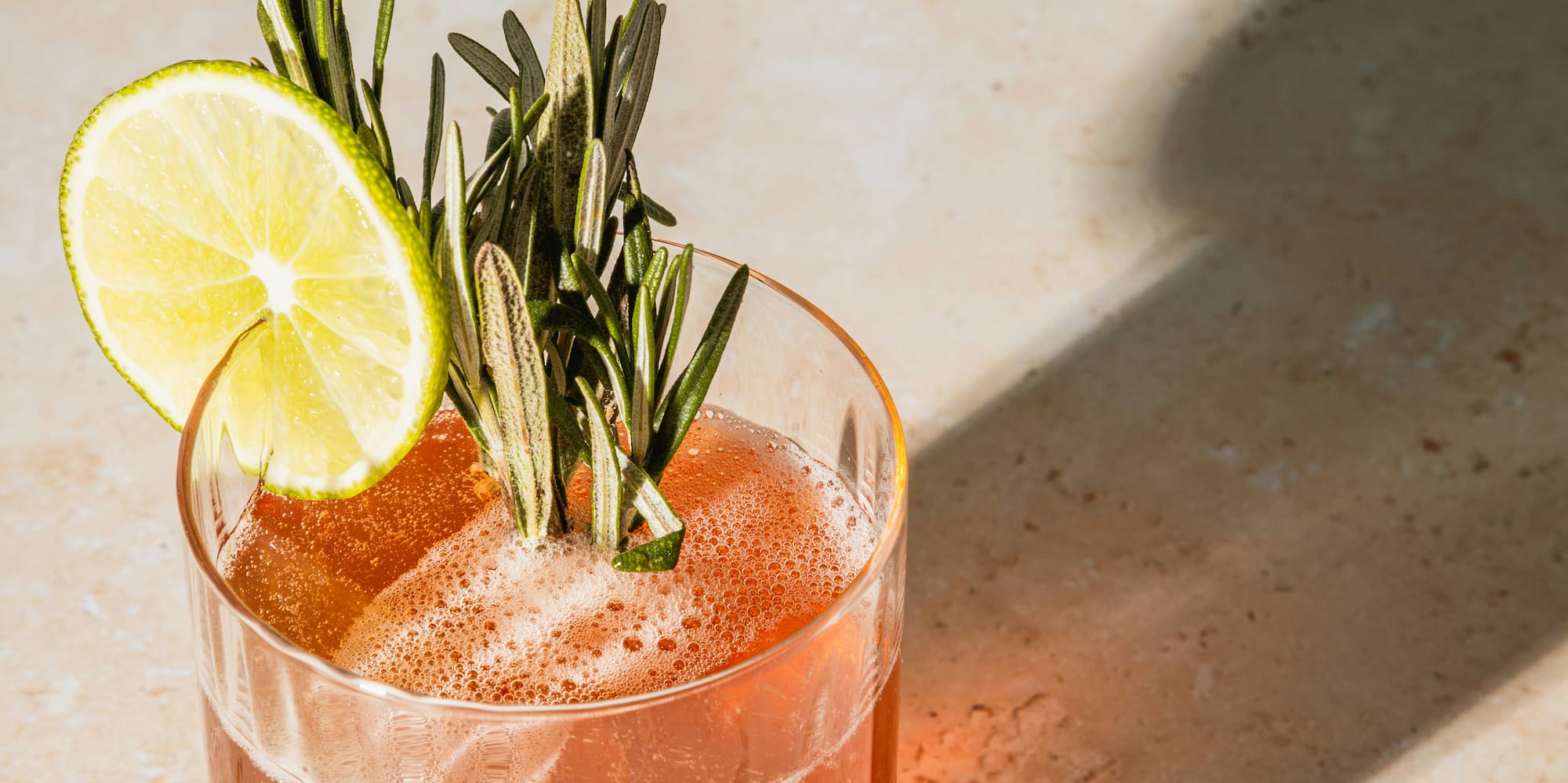 a glass with a drink and a lime slice