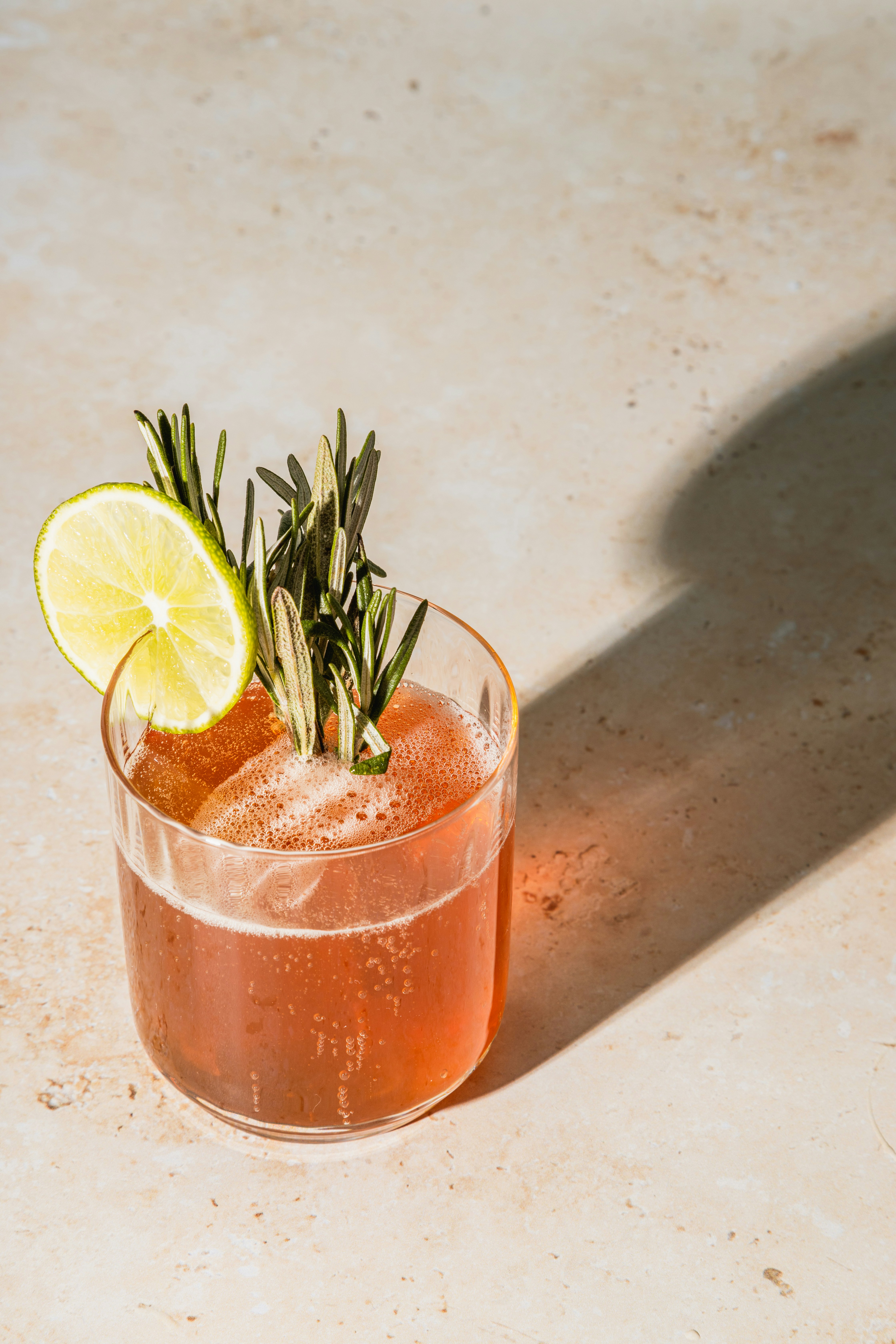 a glass with a drink and a lime slice