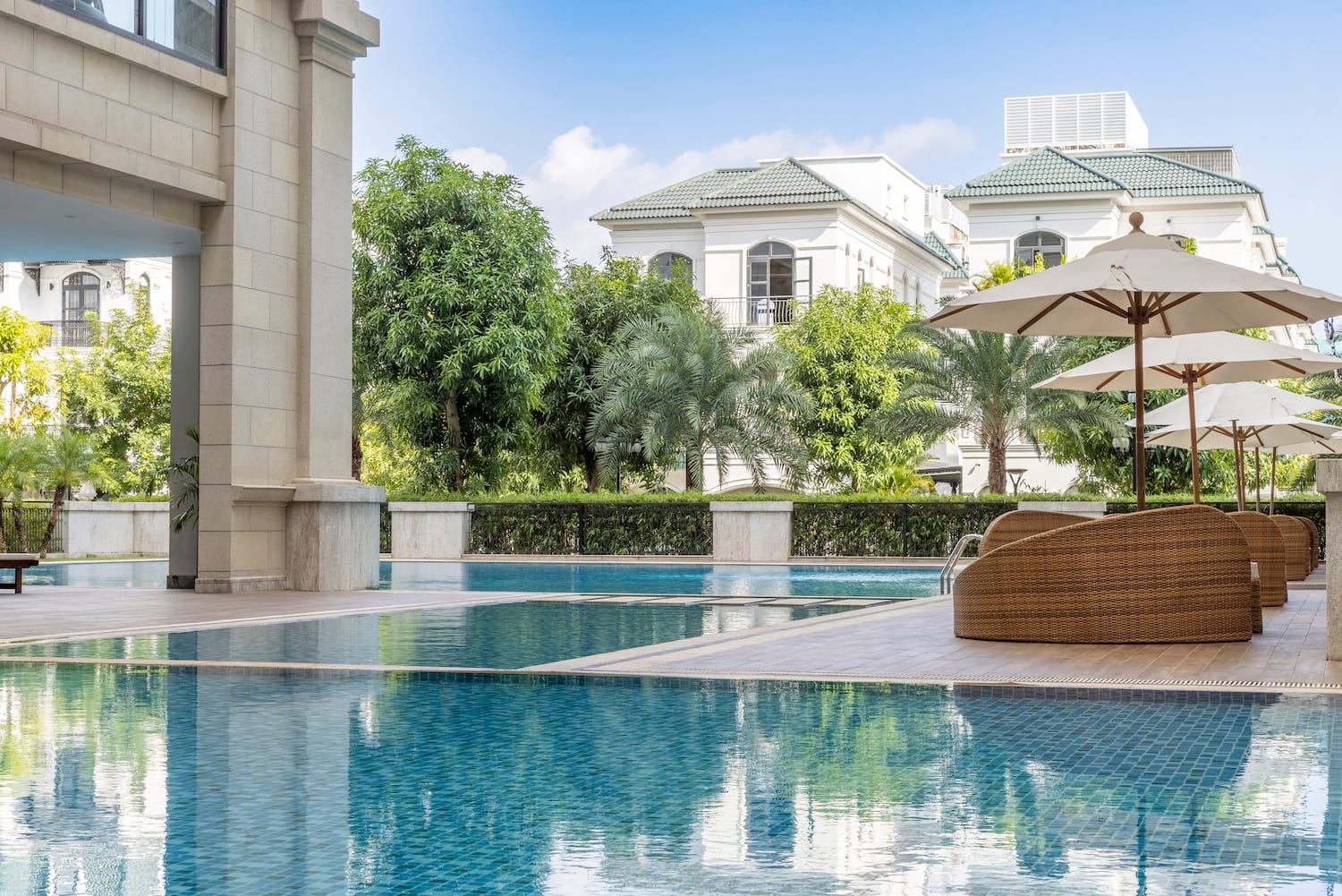 a swimming pool with a chair and umbrellas