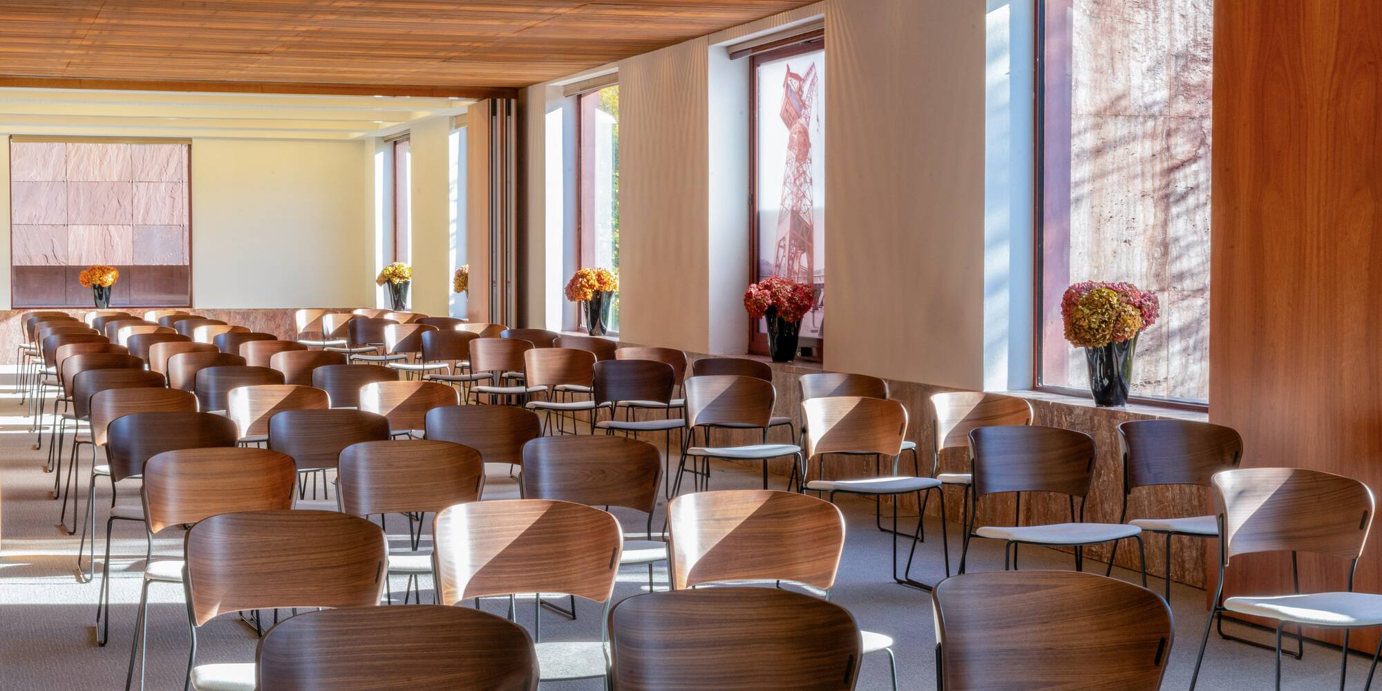 a room with many chairs and flowers