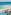 Aerial view: Tropical beach resort with ocean, white sand, pool, and thatched palapas.
