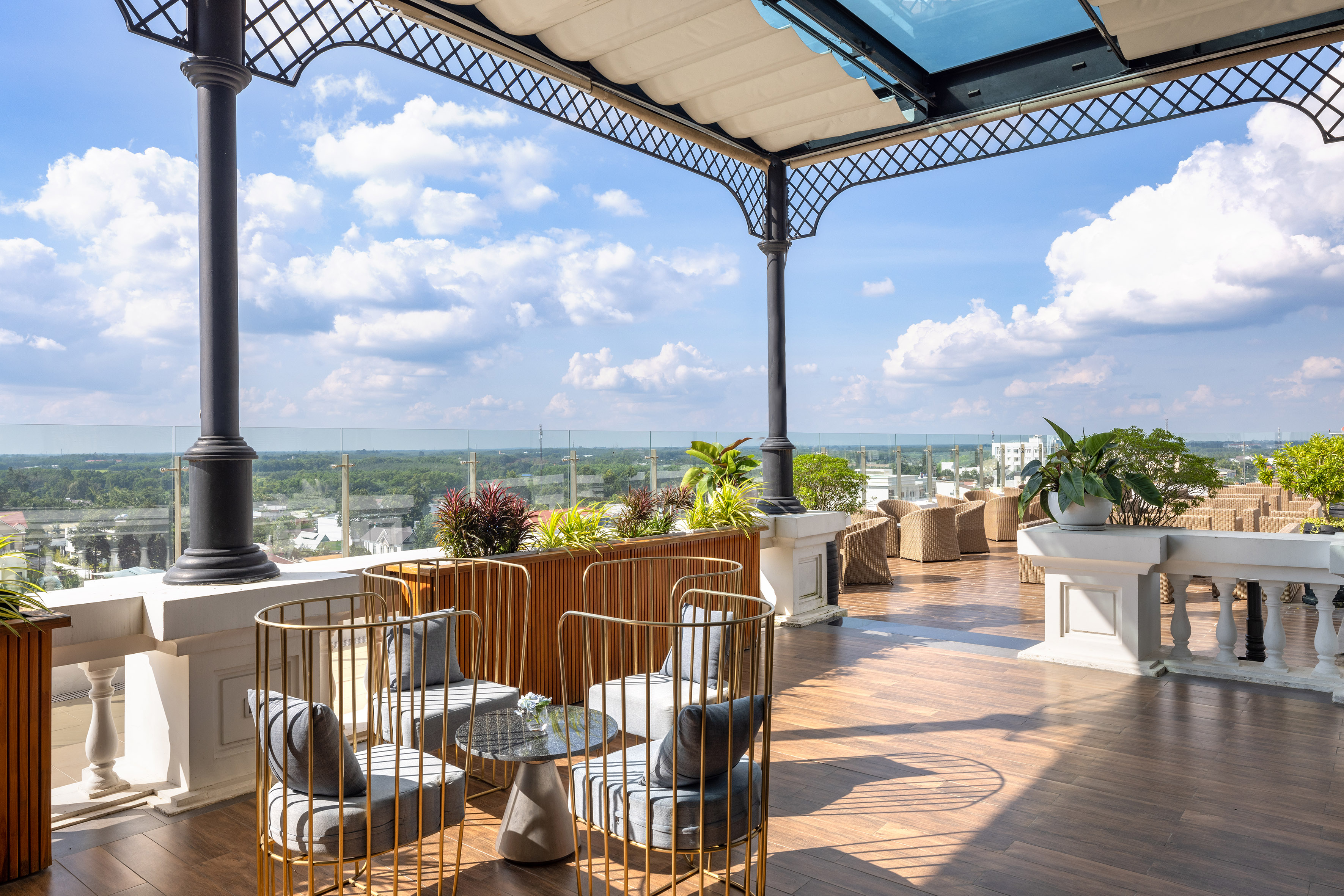Luxury rooftop terrace with outdoor lounge seating and scenic city view.