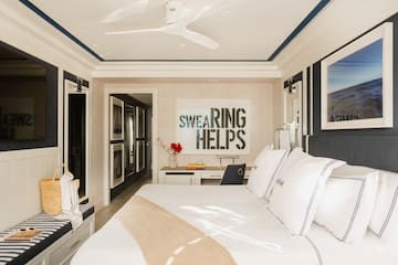 a bedroom with a bed and a fan