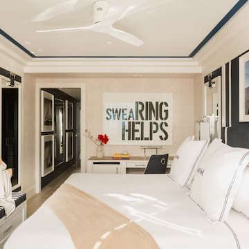 a bedroom with a bed and a fan