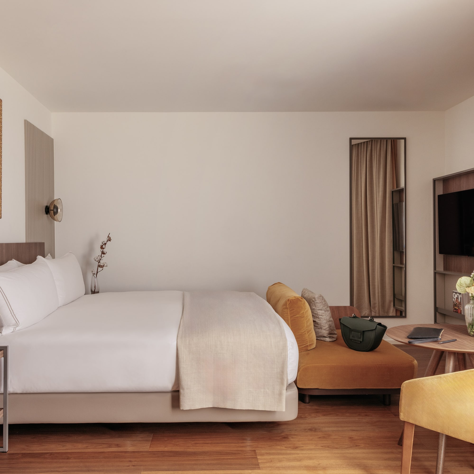 a room with a bed and a television