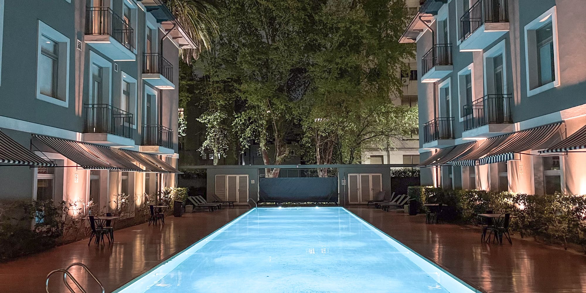 a pool with lights in the back