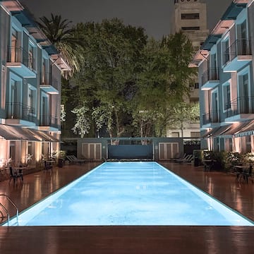 a pool with lights in the back