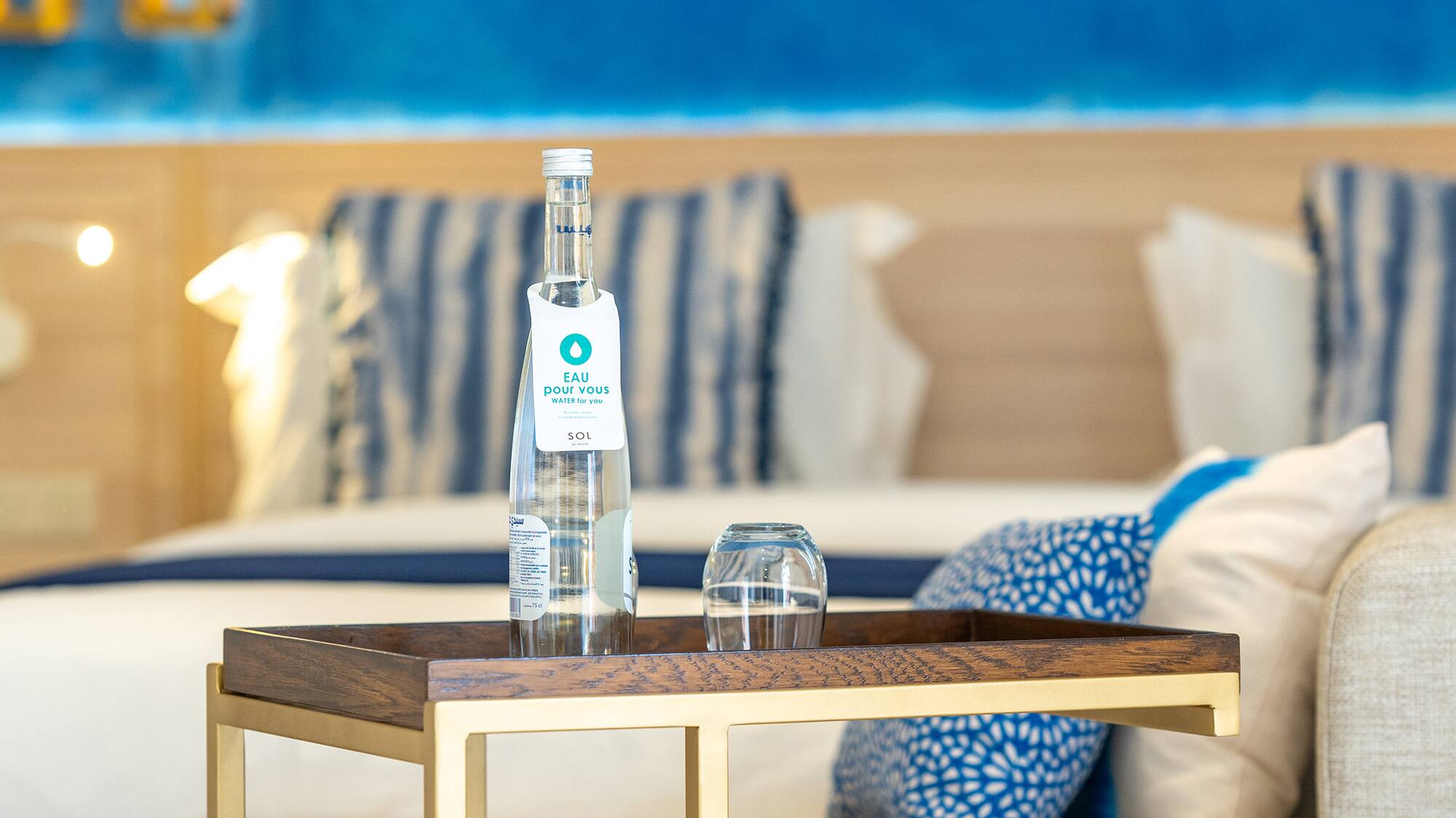 a table with a bottle and glasses on it