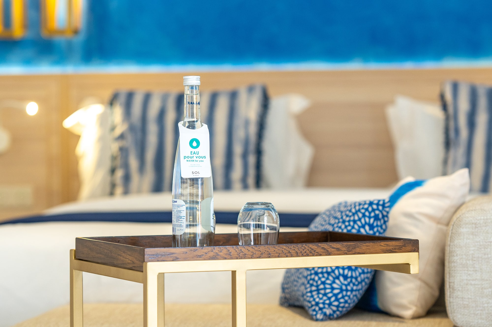 a table with a bottle and glasses on it