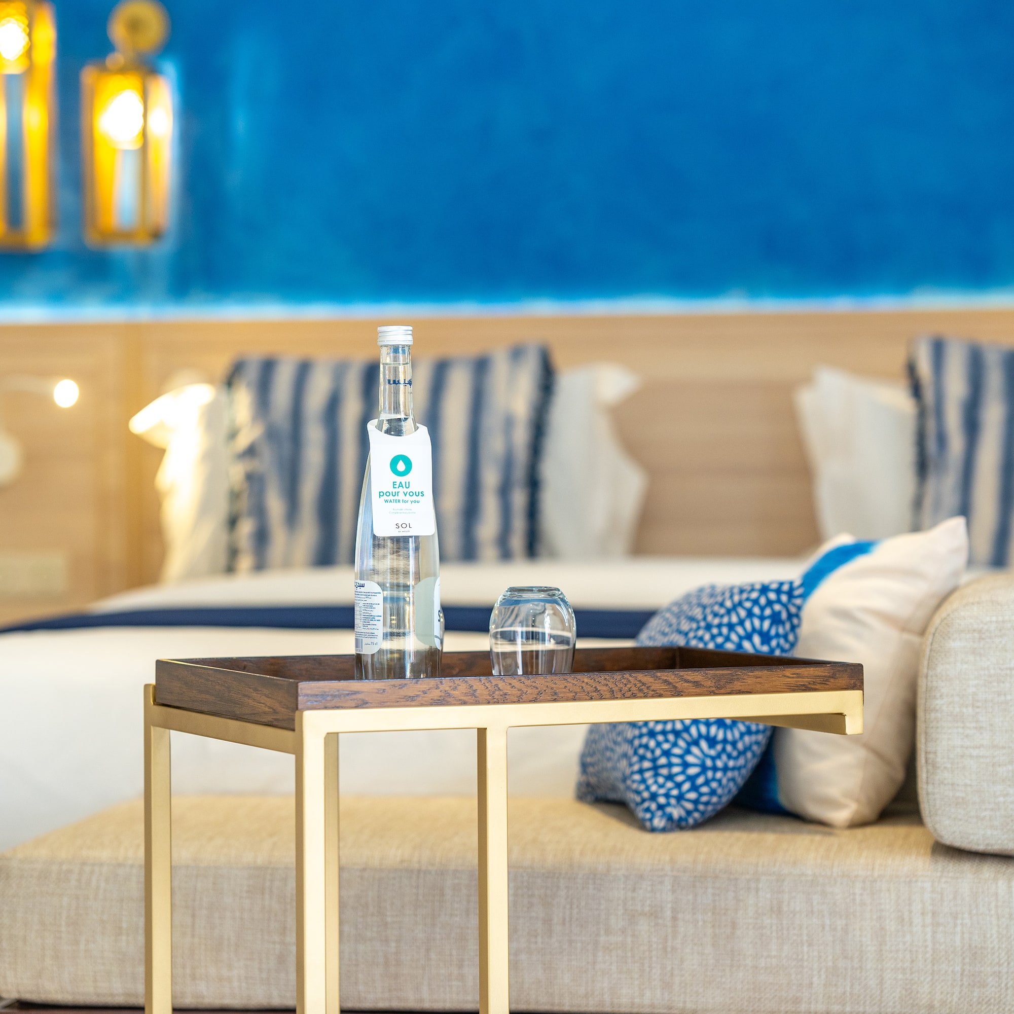 a table with a bottle and glasses on it