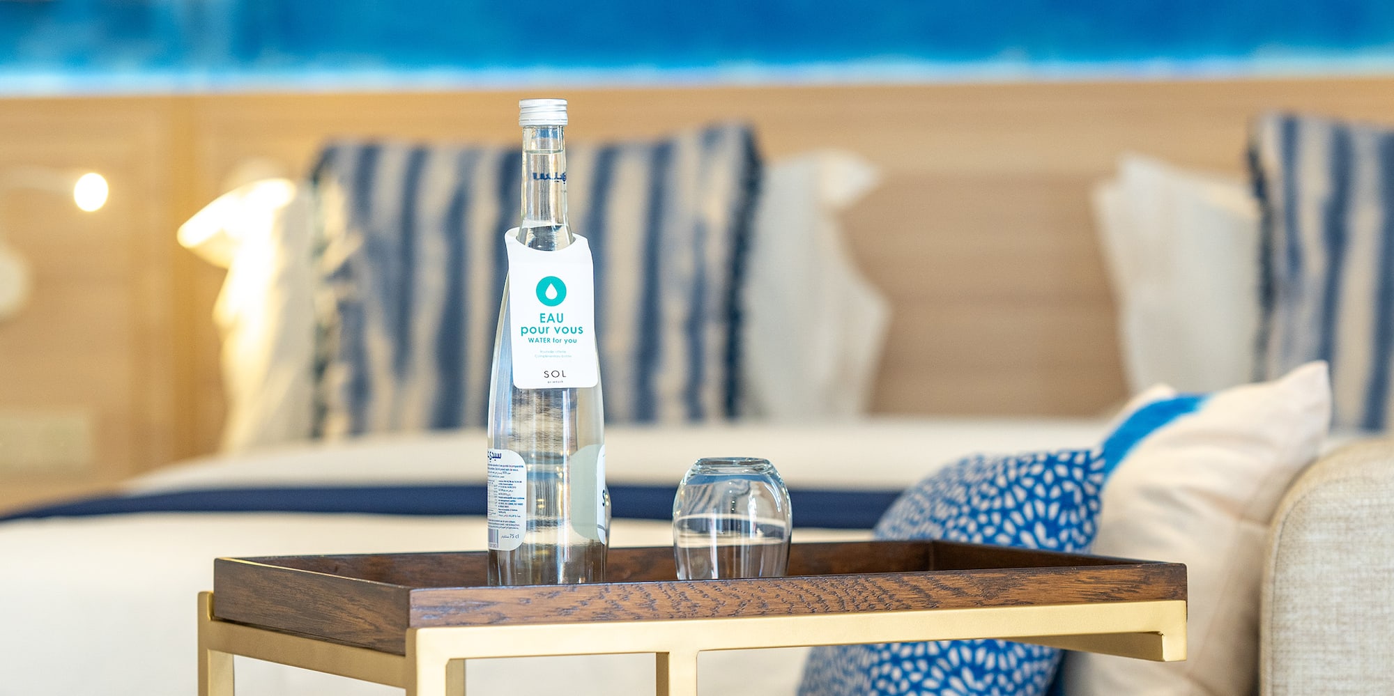 a table with a bottle and glasses on it