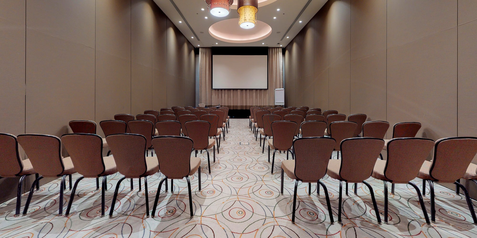 a room with chairs and a projector screen