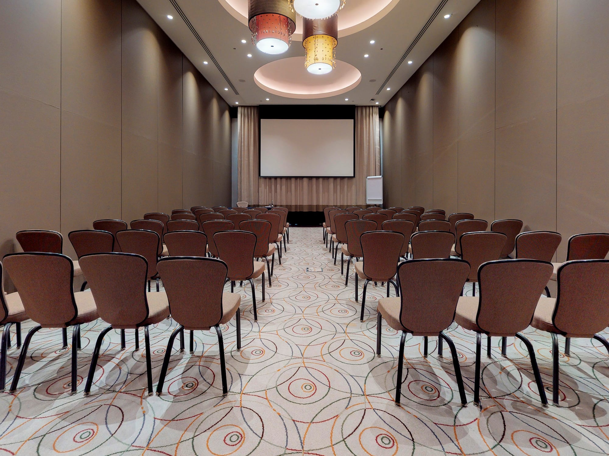 a room with chairs and a projector screen