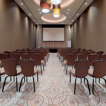a room with chairs and a projector screen