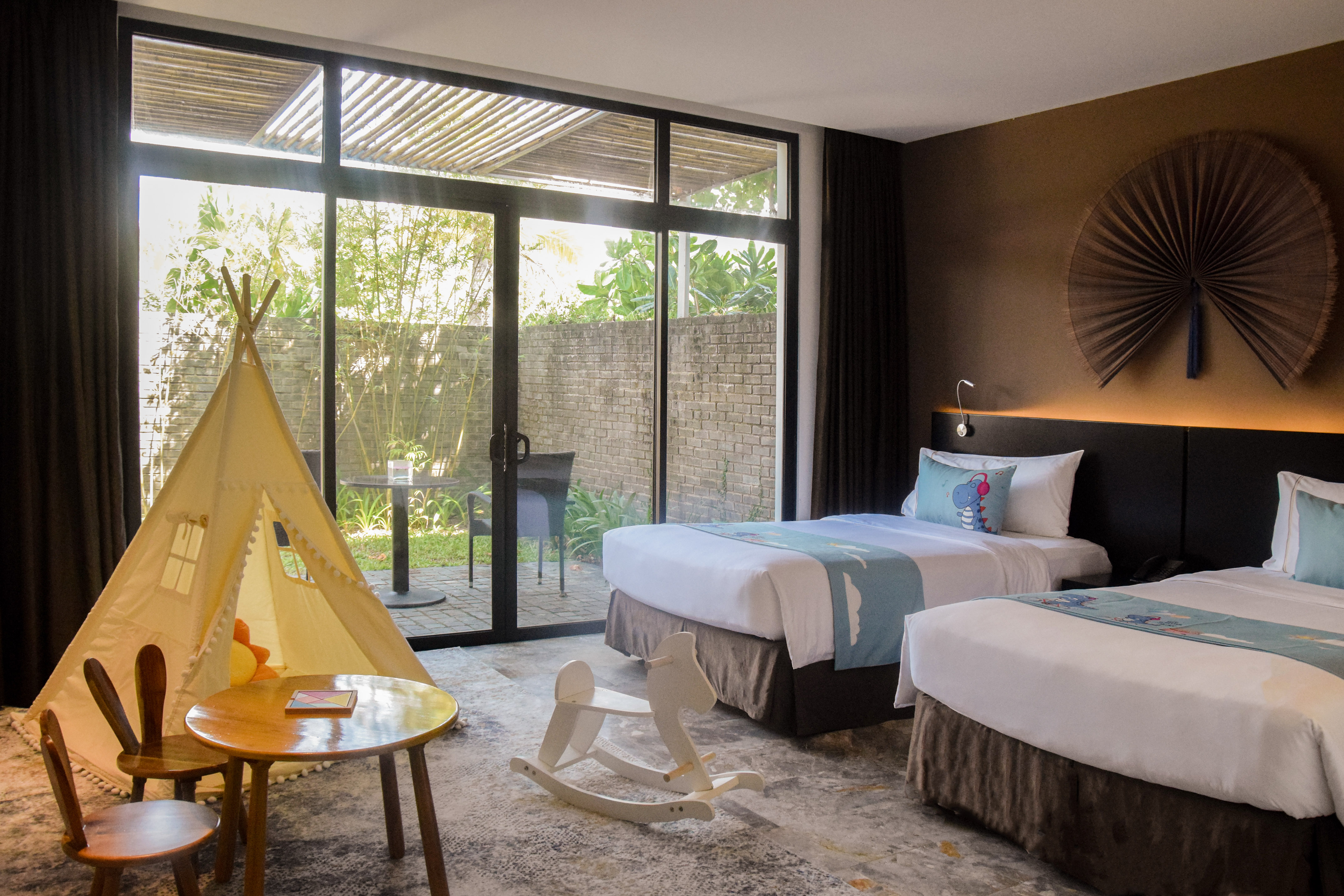 a room with two beds and children's amenitites