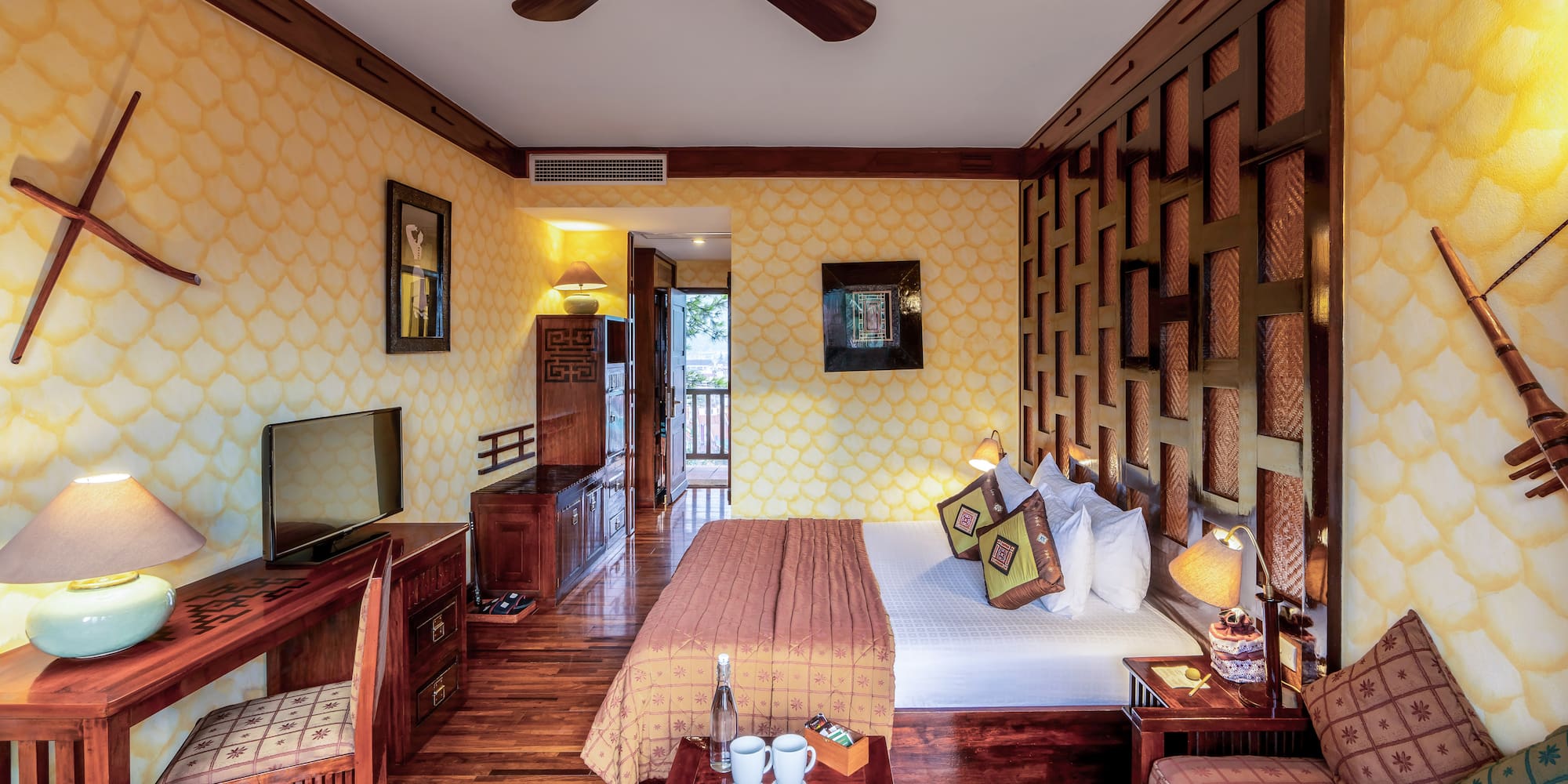 a room with a bed and a television