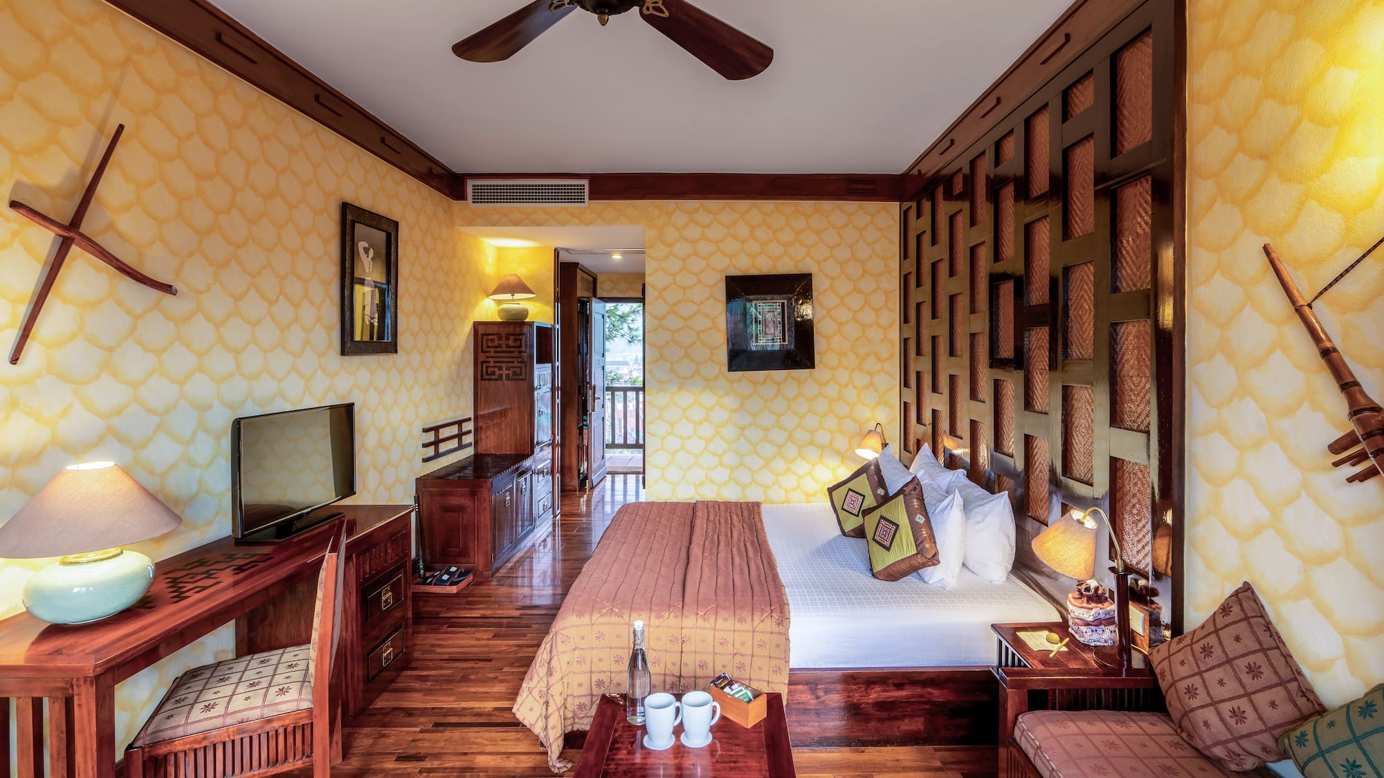 a room with a bed and a television