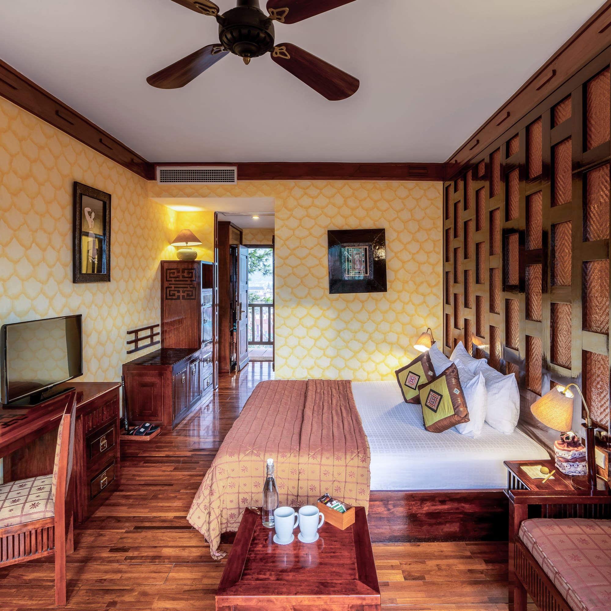 a room with a bed and a television