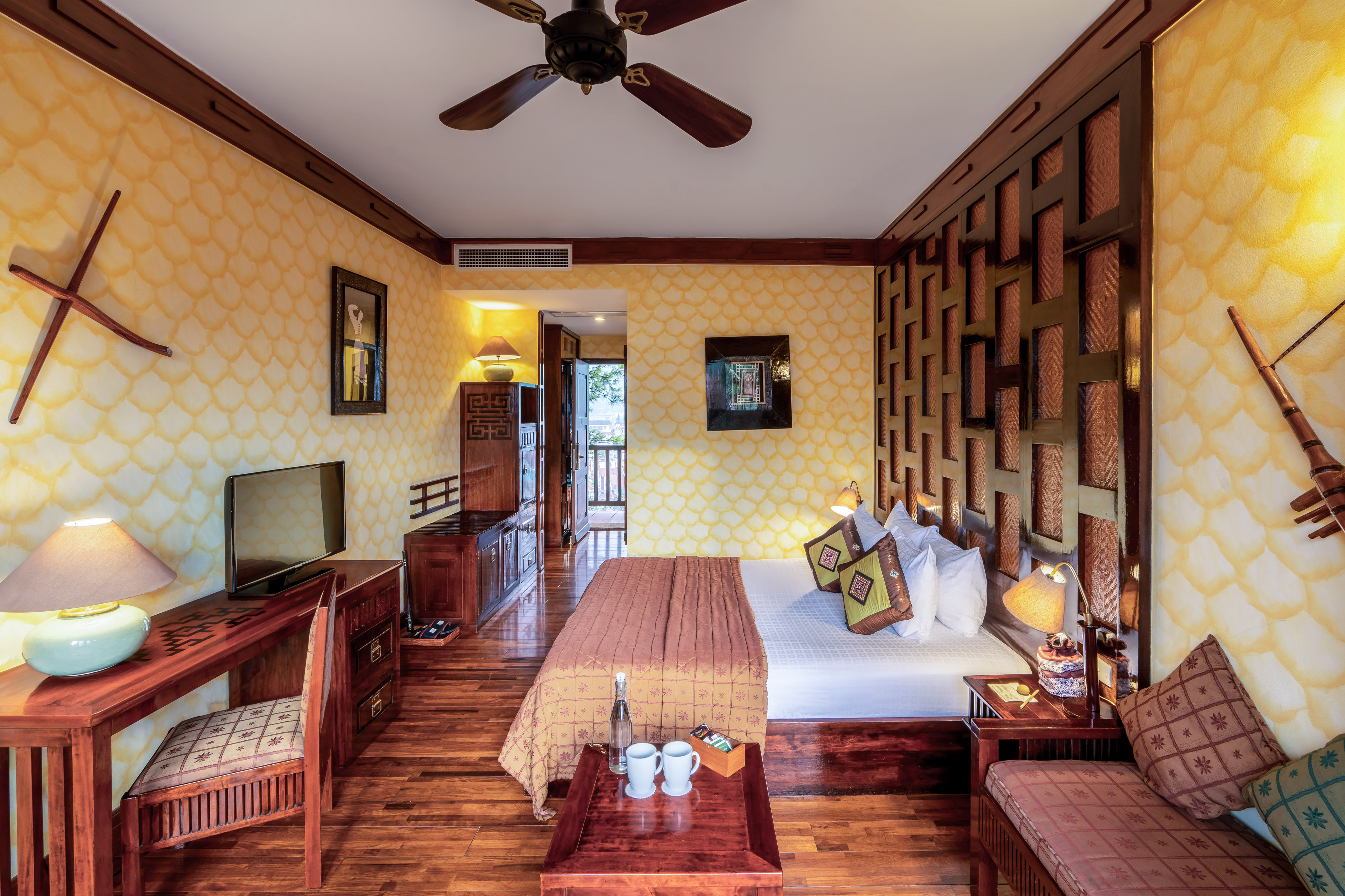 a room with a bed and a television