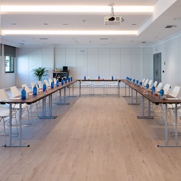 a room with long tables and chairs