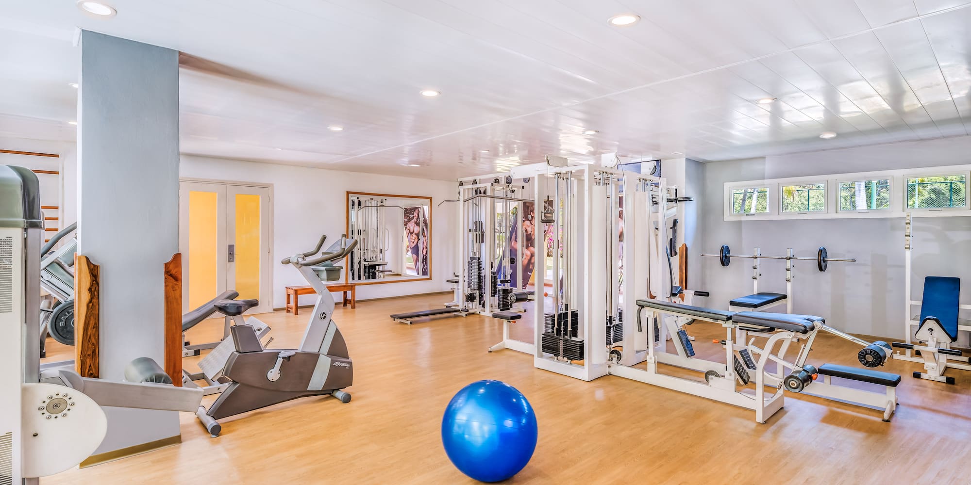 a large room with exercise equipment and a blue ball