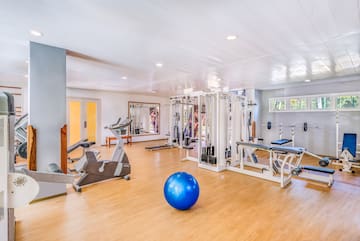 a large room with exercise equipment and a blue ball