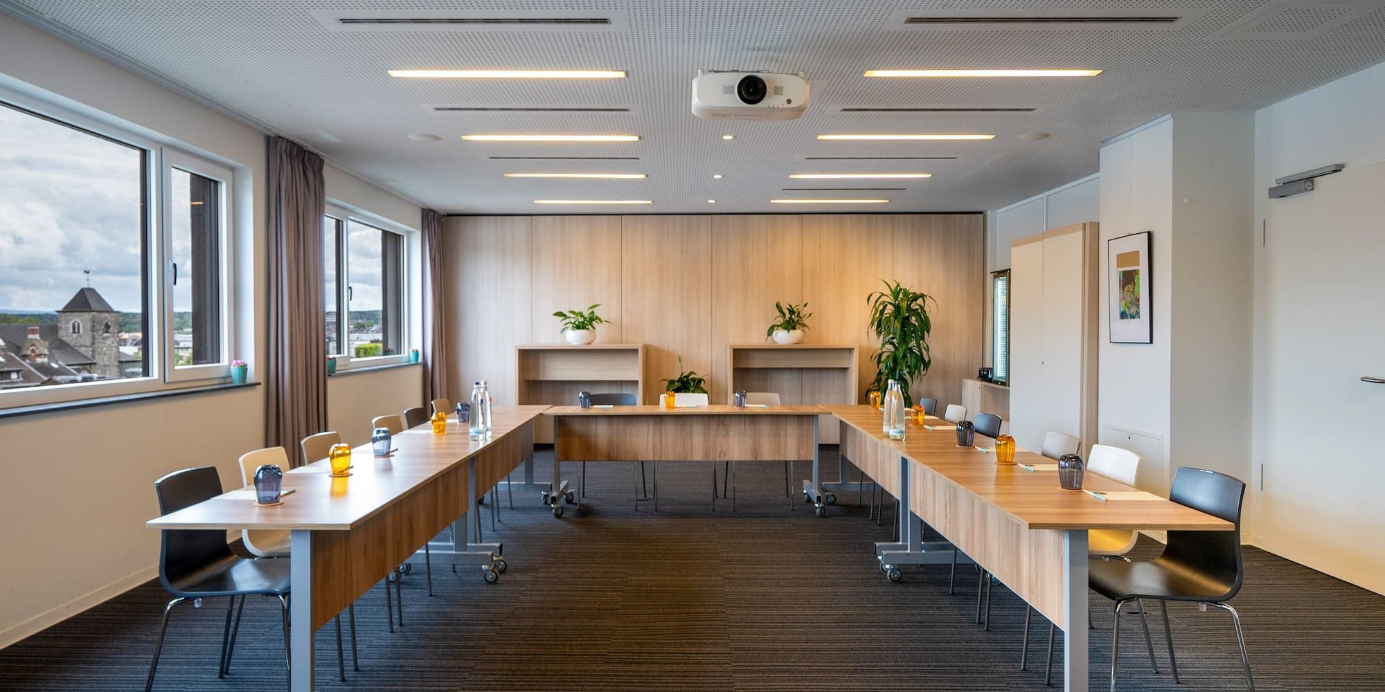 a room with long tables and chairs