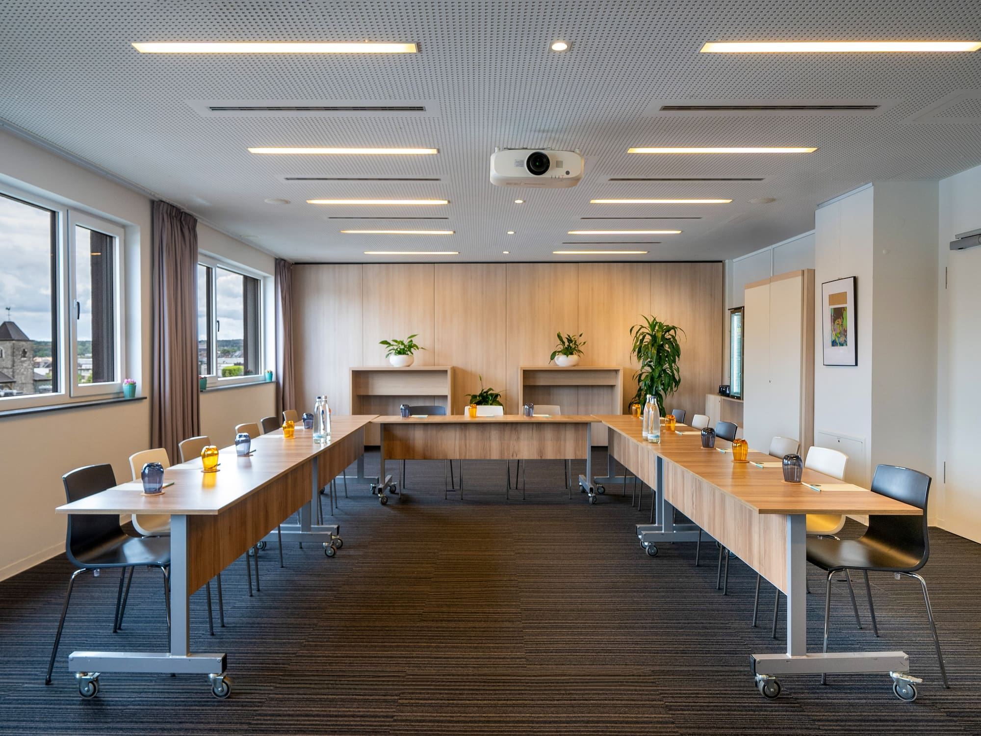 a room with long tables and chairs