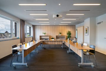 a room with long tables and chairs