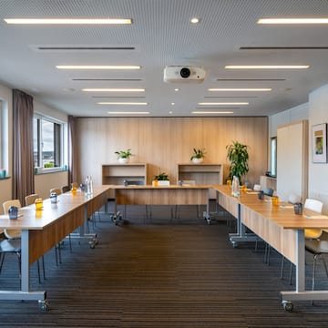 a room with long tables and chairs