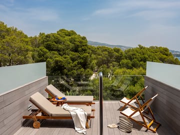 a deck with chairs and a table
