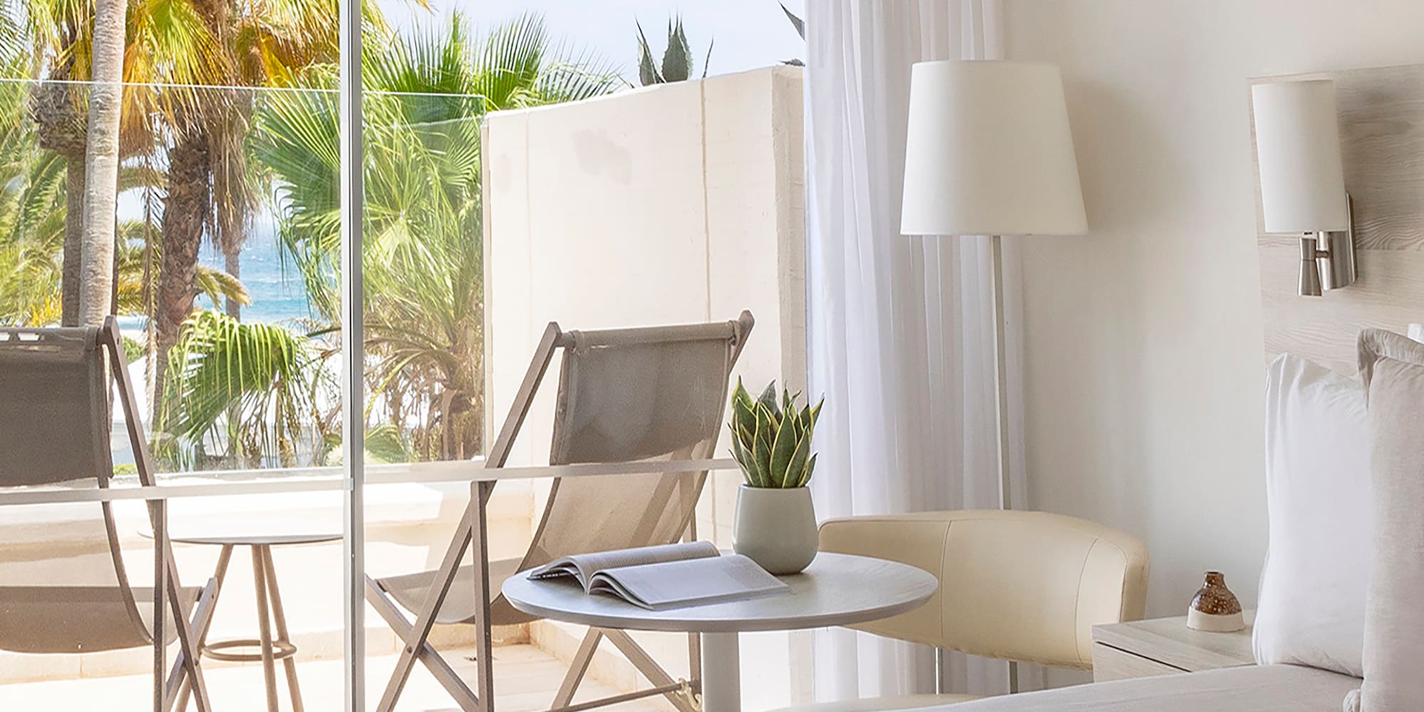 a bedroom with a glass door and a bed