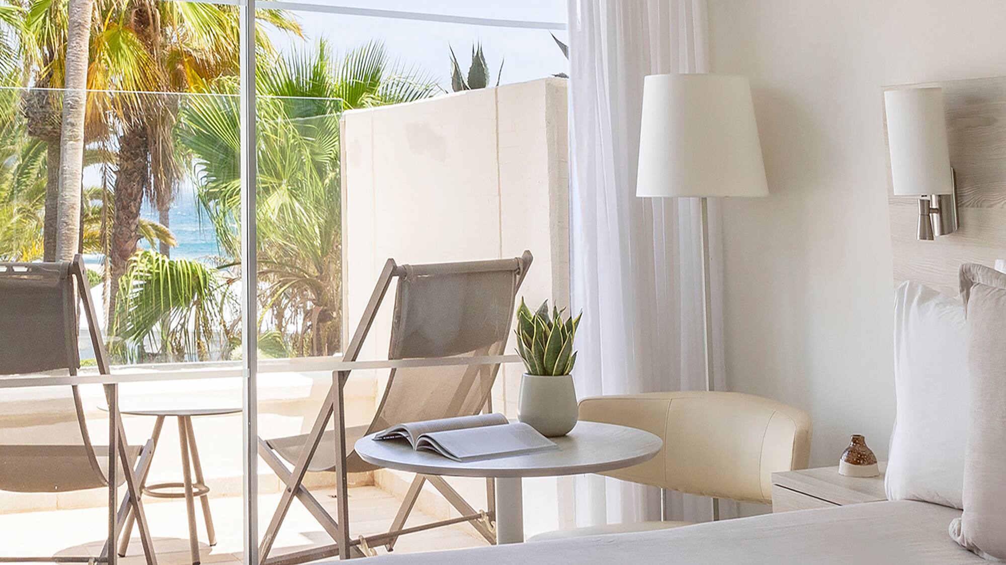 a bedroom with a glass door and a bed