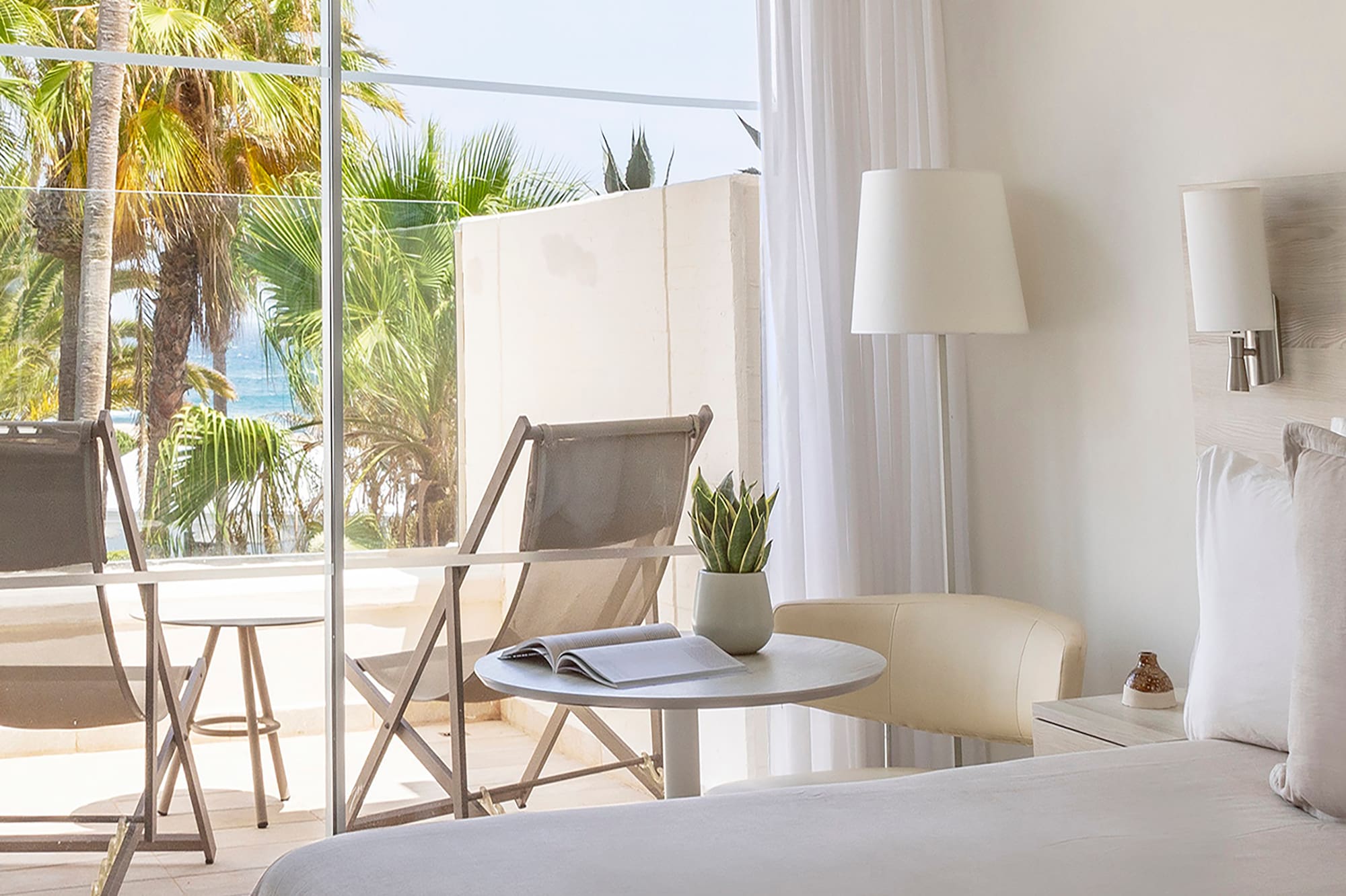 a bedroom with a glass door and a bed