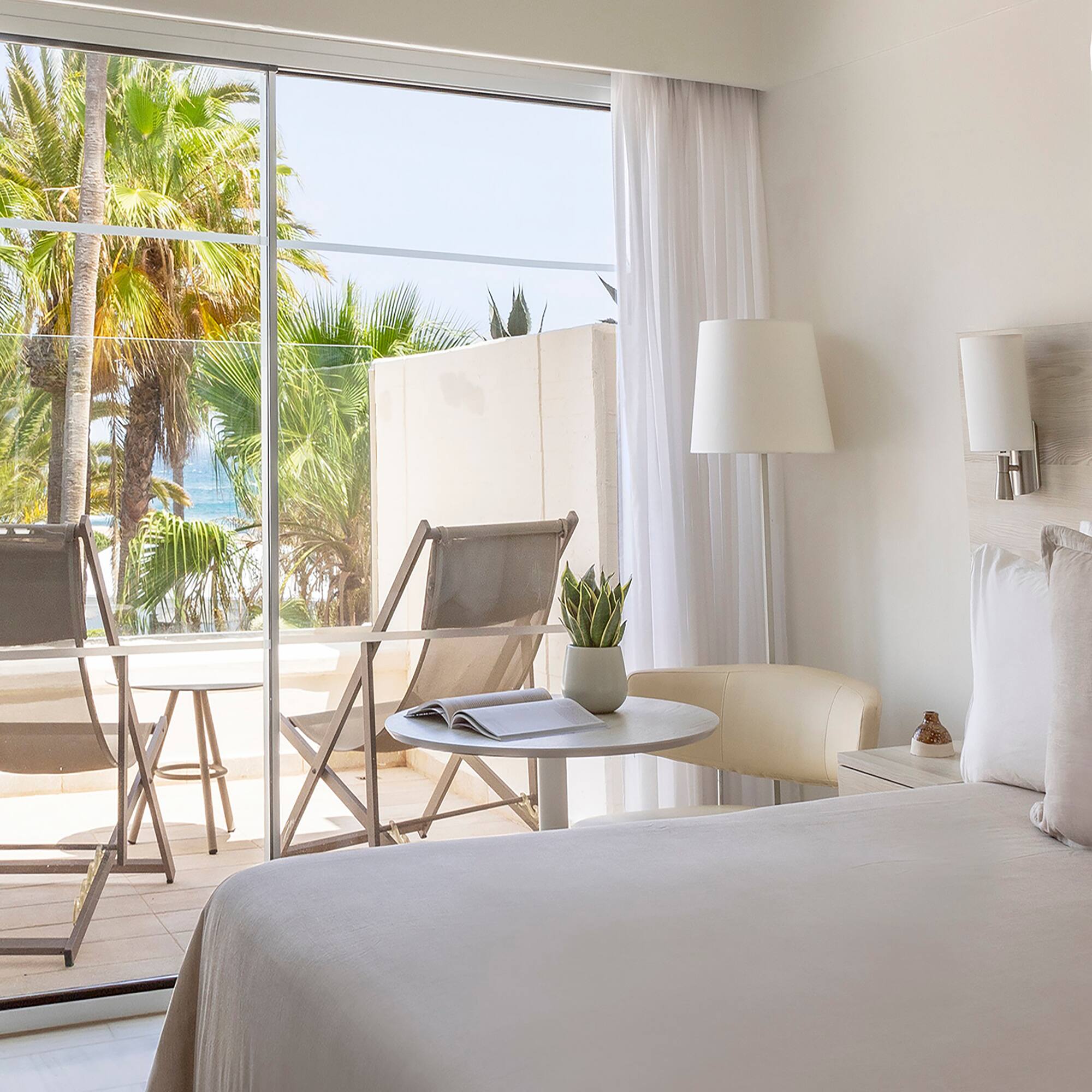 a bedroom with a glass door and a bed