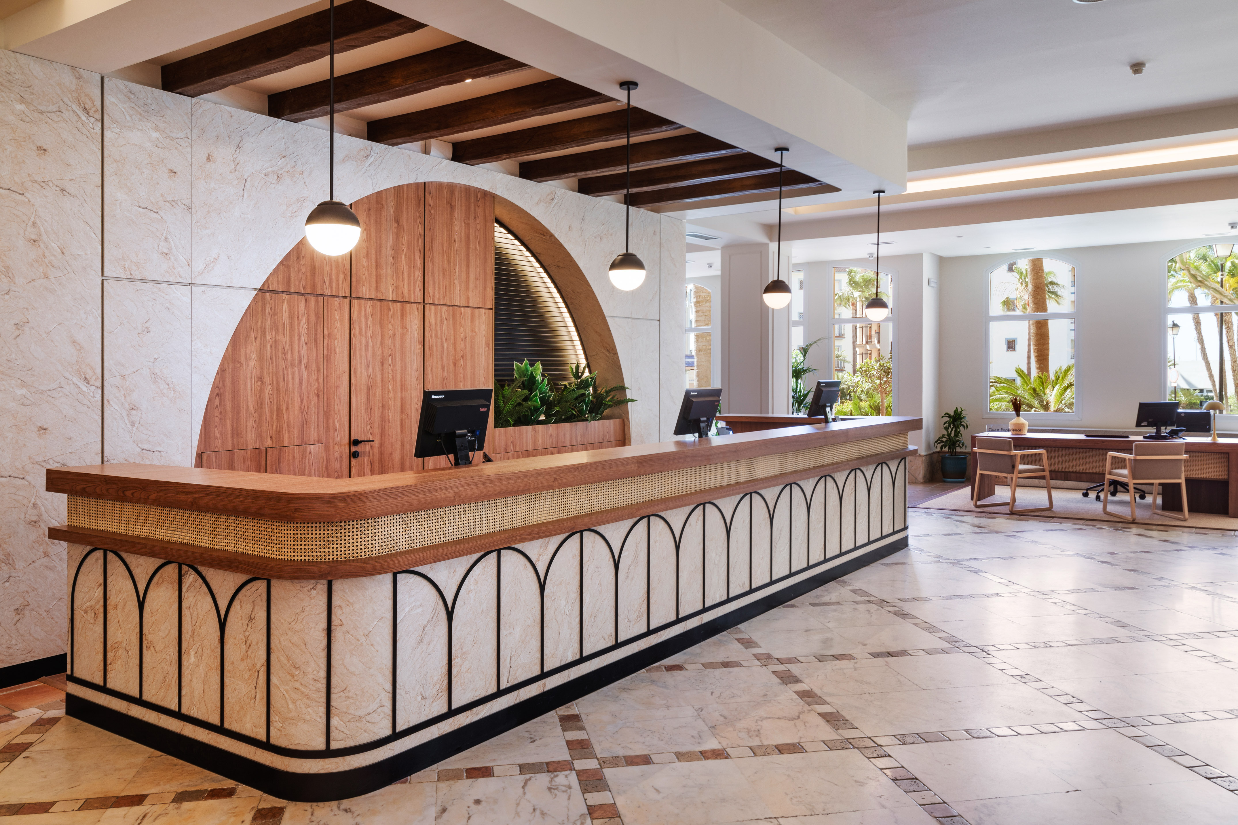 Elegant hotel lobby with modern wood and marble reception desk.