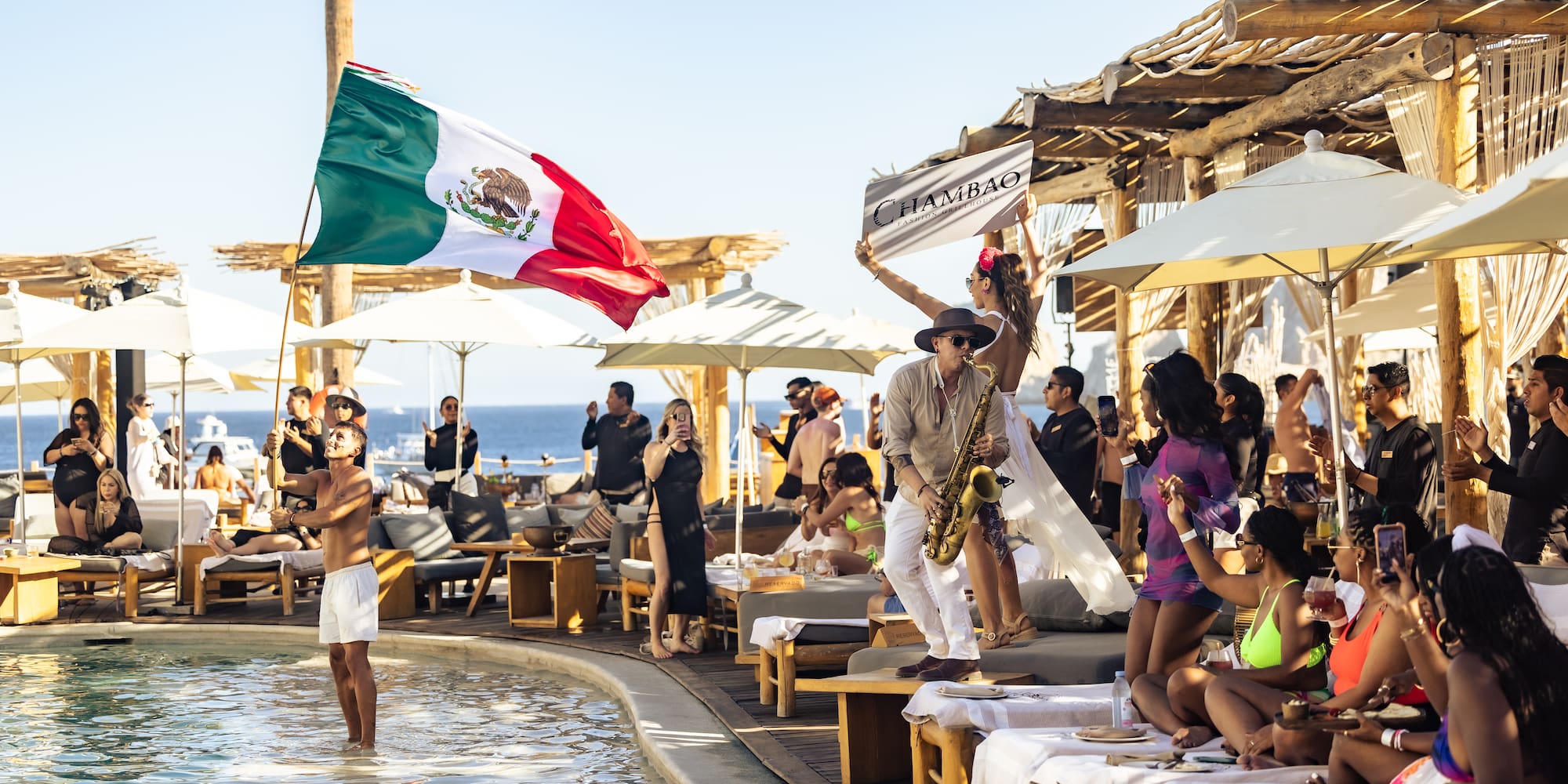 a group of people by a pool with a flag