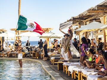 a group of people by a pool with a flag