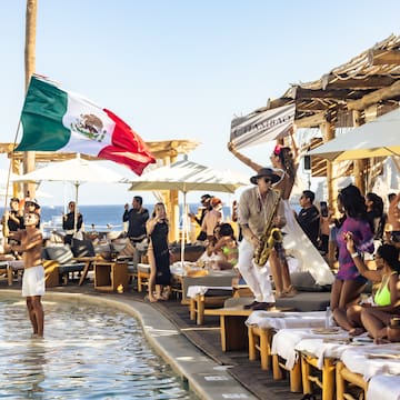 a group of people by a pool with a flag