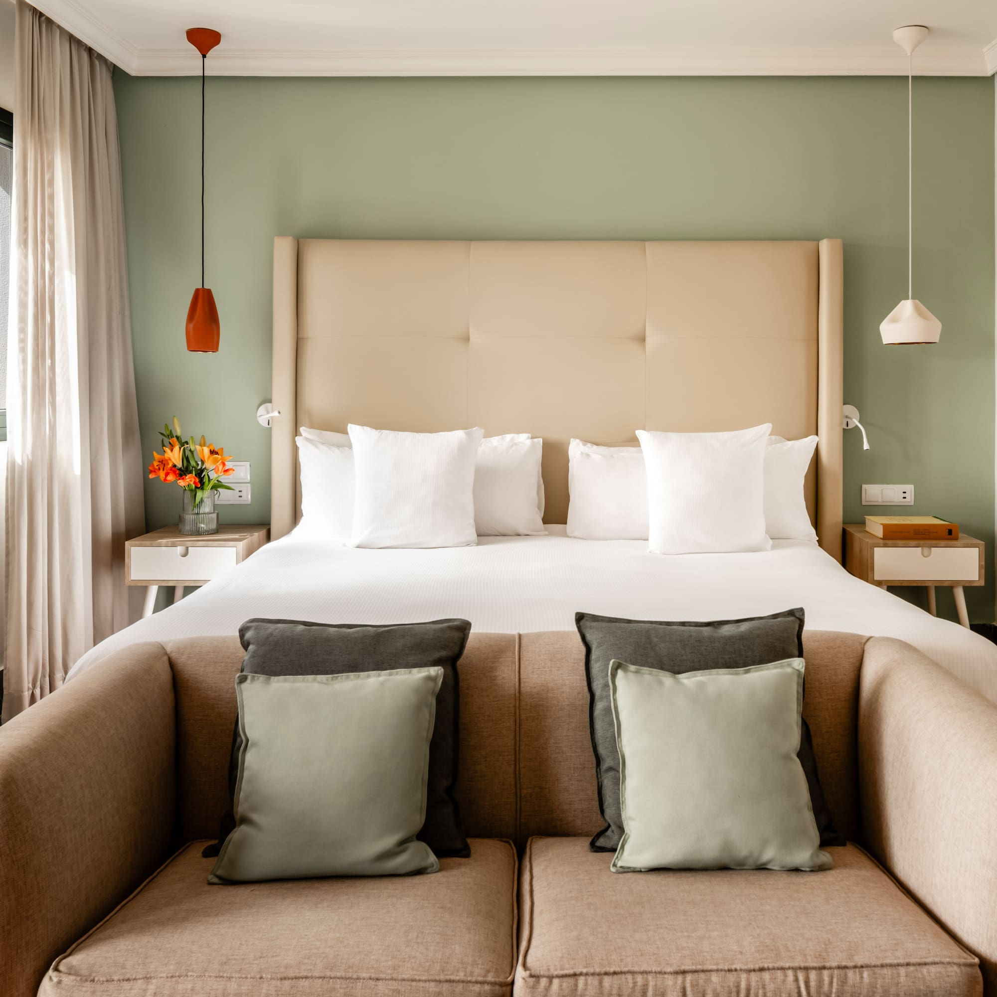 a bed with pillows and a couch in a room