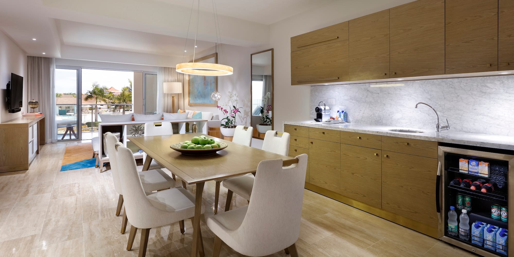 a dining table and kitchen with wood cabinets